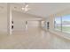 Bright living room with tiled floors, ceiling fan, and access to the backyard at 9896 Sw 56Th Ct, Ocala, FL 34476