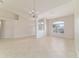 Open-plan living room featuring tile floors and natural light from a large window at 9896 Sw 56Th Ct, Ocala, FL 34476