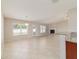 Open concept living space with views of the fireplace, patio door, and adjacent kitchen at 9896 Sw 56Th Ct, Ocala, FL 34476