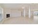 Sun-filled living room with tiled flooring, fireplace, and large windows at 9896 Sw 56Th Ct, Ocala, FL 34476