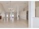 Bright open-plan living area with tile flooring, columns, and neutral decor at 9896 Sw 56Th Ct, Ocala, FL 34476