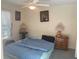 Cozy bedroom featuring neutral walls, a ceiling fan, and a comfortable bed with a blue comforter at 9915 Sw 47Th Ave, Ocala, FL 34476