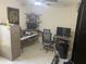 Office setup with a desk, chair, storage shelves, and decor at 9915 Sw 47Th Ave, Ocala, FL 34476