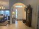 The foyer features tile floors, a chandelier, and a decorative table at 9915 Sw 47Th Ave, Ocala, FL 34476