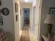 Hallway with art and an area rug connecting different parts of the home at 9915 Sw 47Th Ave, Ocala, FL 34476