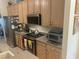 Well-appointed kitchen features stainless steel appliances, cabinetry, and a stylish microwave at 9915 Sw 47Th Ave, Ocala, FL 34476