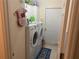 Functional laundry area with a washer, dryer, storage cabinet and convenient access to the exterior at 9915 Sw 47Th Ave, Ocala, FL 34476