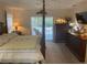 The primary bedroom offers a view of the screened-in pool area at 9915 Sw 47Th Ave, Ocala, FL 34476
