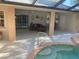 Covered patio overlooking the pool and spa area, perfect for entertaining or relaxation at 9915 Sw 47Th Ave, Ocala, FL 34476