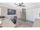 Neutral bedroom with light grey floors, ceiling fan, and closet with sliding doors at 9950 Nw 11Th Ter, Ocala, FL 34475
