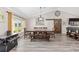 Dining room with vaulted ceilings, decorative lighting, and a sliding barn door at 9950 Nw 11Th Ter, Ocala, FL 34475