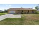 Exterior view of home featuring three-car garage and concrete driveway at 9950 Nw 11Th Ter, Ocala, FL 34475