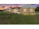 Charming one-story home with a vibrant yellow exterior, blue door, and well-maintained front yard, perfect for Gathering living at 9950 Nw 11Th Ter, Ocala, FL 34475