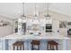 Spacious kitchen with an oversized island and modern lighting at 9950 Nw 11Th Ter, Ocala, FL 34475