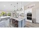 Modern kitchen featuring a spacious island, stainless steel appliances, and easy access to the outdoor pool area at 9950 Nw 11Th Ter, Ocala, FL 34475