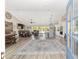 Open-concept living space features wood floors, recessed lighting, and a seamless flow to the kitchen and outdoor area at 9950 Nw 11Th Ter, Ocala, FL 34475