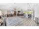Spacious open-concept living area features vaulted ceilings, wood floors, and a seamless connection to the outdoors at 9950 Nw 11Th Ter, Ocala, FL 34475