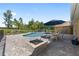 Inviting backyard oasis with a sparkling pool, outdoor dining area, and fire pit for entertaining at 9950 Nw 11Th Ter, Ocala, FL 34475
