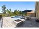 This home offers a pool and outdoor brick patio with a built in fire pit and outdoor cooking space at 9950 Nw 11Th Ter, Ocala, FL 34475