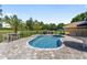 Enjoy this beautiful pool surrounded by mature landscaping and a brick patio; perfect for outdoor living at 9950 Nw 11Th Ter, Ocala, FL 34475