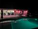 Night view of pool and patio area with outdoor seating with colored lights at 9950 Nw 11Th Ter, Ocala, FL 34475