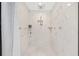 Walk-in shower featuring white marble tile and dual shower heads at 9950 Nw 11Th Ter, Ocala, FL 34475
