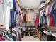 Organized walk-in closet with ample hanging and storage space for clothing and accessories at 9950 Nw 11Th Ter, Ocala, FL 34475