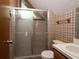 Bathroom featuring a tiled shower, wallpaper, and wood accents at 11420 Nw 110Th Ave, Reddick, FL 32686