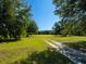 Scenic view of land with a dirt path running through a grassy field under a clear blue sky at 11420 Nw 110Th Ave, Reddick, FL 32686