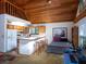 Open living space with kitchen, breakfast bar, and sleeping area under wood ceiling at 11420 Nw 110Th Ave, Reddick, FL 32686