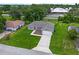 Aerial view of a home showcasing well-maintained landscaping, a long driveway, and a welcoming entrance at 12 Oak Circle Pass, Ocala, FL 34472