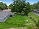 Aerial view of the backyard showing the large yard with a covered patio and mature trees at 12 Oak Circle Pass, Ocala, FL 34472