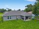 Aerial view of backyard with a covered patio, mature trees, and fenced yard at 12 Oak Circle Pass, Ocala, FL 34472