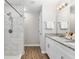 Bathroom with walk-in shower, granite countertops, and double sinks at 12 Oak Circle Pass, Ocala, FL 34472
