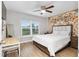 Cozy bedroom with a large window, decorative tapestry, and comfortable furnishings at 12 Oak Circle Pass, Ocala, FL 34472
