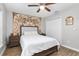 Bedroom with double bed, overhead fan, tapestry and wood-look flooring at 12 Oak Circle Pass, Ocala, FL 34472