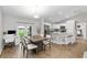 Bright dining area that connects to the kitchen with a large table, workstation, and sliding glass doors at 12 Oak Circle Pass, Ocala, FL 34472