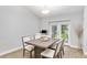 Inviting dining area featuring a large table and chairs with a view of the landscaped backyard at 12 Oak Circle Pass, Ocala, FL 34472