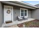 Charming front porch featuring seating and a decorative wreath on the front door at 12 Oak Circle Pass, Ocala, FL 34472