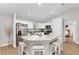Modern kitchen featuring granite countertops, stainless steel appliances, and an island with barstool seating at 12 Oak Circle Pass, Ocala, FL 34472