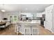 Open kitchen with stainless appliances, an island with bar seating, and views of the dining and living areas at 12 Oak Circle Pass, Ocala, FL 34472