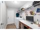 Functional laundry room with modern appliances, shelving, and a desk area at 12 Oak Circle Pass, Ocala, FL 34472