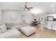 Open concept living room with a ceiling fan, dining area, and breakfast bar for seamless entertaining at 12 Oak Circle Pass, Ocala, FL 34472