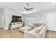 Cozy living room with a sectional sofa, television, and stylish console for relaxation and entertainment at 12 Oak Circle Pass, Ocala, FL 34472