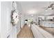 Bright, open-concept living space with wood floors, seamlessly connecting the living room, dining area, and kitchen at 12 Oak Circle Pass, Ocala, FL 34472