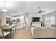 Bright, open-concept living space with wood floors, seamlessly connecting the living room, dining area, and kitchen at 12 Oak Circle Pass, Ocala, FL 34472