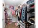 Organized walk-in closet featuring ample shelving and hanging storage for clothes and accessories at 12 Oak Circle Pass, Ocala, FL 34472