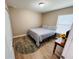 Small bedroom featuring wood laminate flooring and a round decorative rug at 12840 Sw 60Th Ct, Ocala, FL 34473