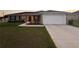 Charming single-story home with a well-maintained lawn and a two car attached garage at 12840 Sw 60Th Ct, Ocala, FL 34473