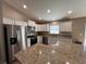 Modern kitchen with stainless steel appliances, granite countertops, and ample cabinet space at 12840 Sw 60Th Ct, Ocala, FL 34473